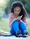 Black woman, studying and park of a student with study books outdoor writing notes. Notebook, learning and girl with Royalty Free Stock Photo