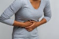 Black woman suffering from gastritis, touching her tummy