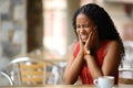 Black woman suffering tmj in a restaurant Royalty Free Stock Photo