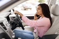 Black woman talking on cell phone while driving car Royalty Free Stock Photo