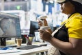 Black woman technician testing solar panel designs on VR headset, Royalty Free Stock Photo