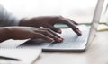 Black woman typing on laptop keyboard while working in office Royalty Free Stock Photo