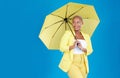 Black woman, umbrella and face with smile in studio for life insurance and security isolated on blue background. Shield Royalty Free Stock Photo