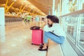 black Woman upset and frustrated at the airport with flight canceled