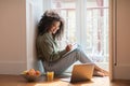 Black Woman Using Laptop Taking Notes In Notebook At Home Royalty Free Stock Photo