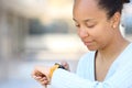Black woman using smartwatch in the street Royalty Free Stock Photo