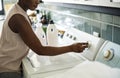 Black woman using washing machine Royalty Free Stock Photo