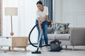 Black woman vacuum cleaner, smile in living room and cleaning tiles floor in home for hygiene. Woman cleaner, happy with Royalty Free Stock Photo