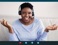 Black Woman Wearing Headset Having Video Conference