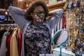 Black woman wearing a mask is shopping around for clothes Royalty Free Stock Photo