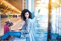 Black woman working with laptop at the airport waiting at the wi Royalty Free Stock Photo