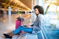 Black woman working with laptop at the airport waiting at the wi Royalty Free Stock Photo