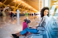 Black woman working with laptop at the airport waiting at the wi Royalty Free Stock Photo