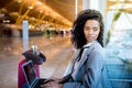 Black woman working with laptop at the airport waiting at the wi Royalty Free Stock Photo