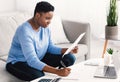 Black woman writing business report working on laptop at home Royalty Free Stock Photo