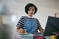 Black woman writing notes, studying on laptop and working on living room desk from home. African American girl, digital Royalty Free Stock Photo