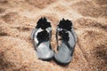 Black women flip flops on beach sand