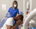 A black woman patient is spitting out at the dental clinic