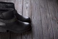 Black women`s boots on a brown wooden background