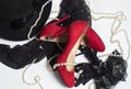 Black women`s hat, stockings, gloves, red shoes and pearl beads on a white Royalty Free Stock Photo