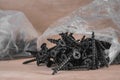 Black Wood Screws Pile in Plastic Bag on Wood Background Royalty Free Stock Photo