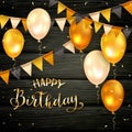 Black Wooden Background with Golden Birthday Balloons and Pennants Royalty Free Stock Photo