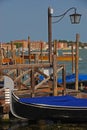 Gondola Ferro moored at Wooden Pier with street lamp at Venice