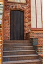 Black wooden door in the old tower. Royalty Free Stock Photo