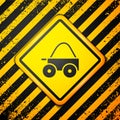 Black Wooden four-wheel cart with hay icon isolated on yellow background. Warning sign. Vector