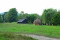 Black wooden house on the field Royalty Free Stock Photo