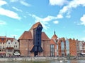 Black wooden medieval crane building on the Gdansk waterfront