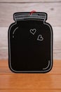 Black wooden tag with white hearts on the wooden background