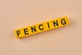 Black word fencing written on yellow cubes close up. Royalty Free Stock Photo