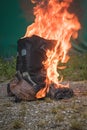 Worn motorcycle boots burning Royalty Free Stock Photo