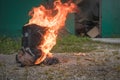 Worn motorcycle boots burning Royalty Free Stock Photo