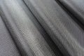 Black woven carbon fiber or Kevlar texture for background.