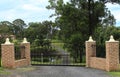 Black wrought iron entrance gates set in brick fence