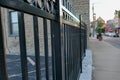 Black wrought iron fence along a sidewalk Royalty Free Stock Photo