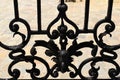 black wrought iron fence. forged steel decorative elements. soft blurred stucco old building elevation Royalty Free Stock Photo