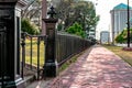 Black wrought iron fence next to sidewalk