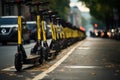 Black and yellow electric scooters lined up along the road in the city, with distant blurred lights.