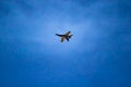 A black and yellow fighter jet performing aerial maneuvers solo