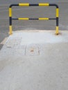 Black and yellow metal safety barrier. Fixed gate barrier. Beaconing and signaling concept. Roadblock Road Barrier Close up