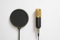 The black yellow microphone with the wire and pop filter on a white background. Minimalism. Copy space for text Royalty Free Stock Photo