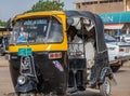 Black and yellow painted Tuctuc in a street of Dongola Royalty Free Stock Photo