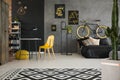 Black and yellow posters on concrete wall in spacious flat inter Royalty Free Stock Photo