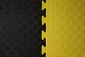 Black and yellow puzzle, rubber Mat, background, texture close-up Royalty Free Stock Photo
