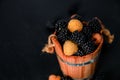 Black and yellow raspberries in a wooden basket on background. Frame. Copy space. Top view. Royalty Free Stock Photo