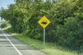 Black and yellow road sign standing next to the street in Colombia. Royalty Free Stock Photo