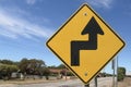 Black and yellow road sign warning of Sharp Turn To The RIght, Then Sharp Turn To The Left ahead Royalty Free Stock Photo